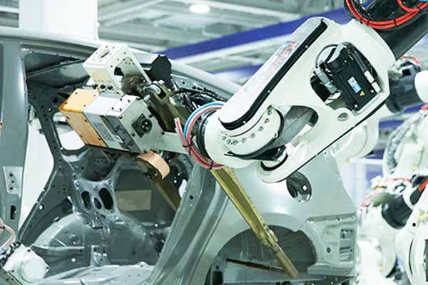 industrial robot in an assembly environment with cars
